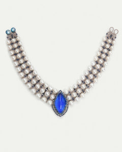 Blue kyanite and freshwater pearl necklace with silk strands and intricate detailing.