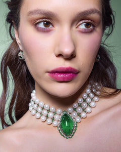 Pearl choker necklace with large green teardrop gemstone and silver accents.