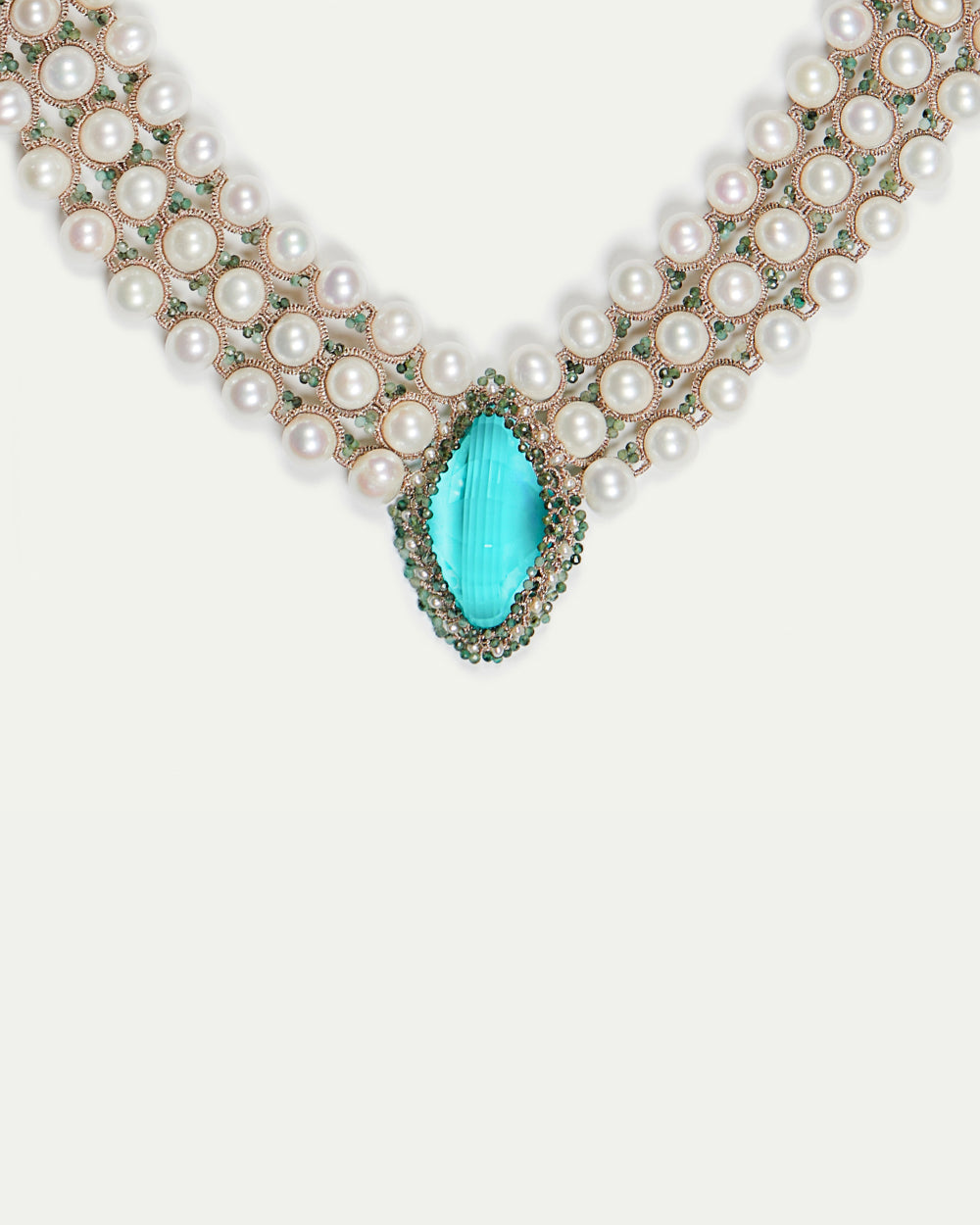 Green silk necklace with freshwater pearls and sapphire detail.