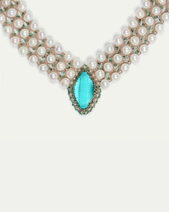 Green silk necklace with freshwater pearls and sapphire detail.