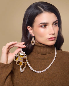 Gold KIARA earrings with silk, crystal, garnet, intricate textures, and detailed craftsmanship.