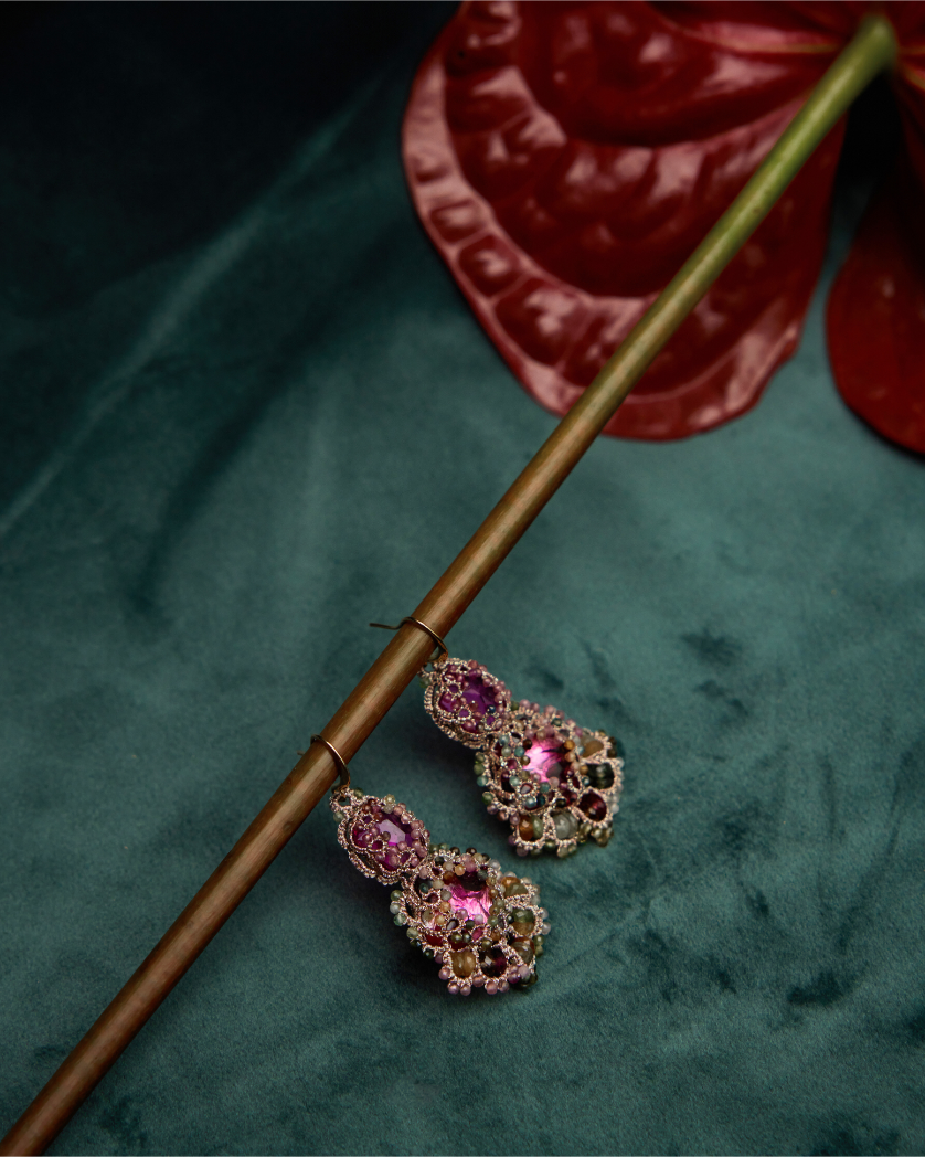 Kimberly earrings with pink crystals, multicolored gemstones, and gold-plated hooks on teal background.