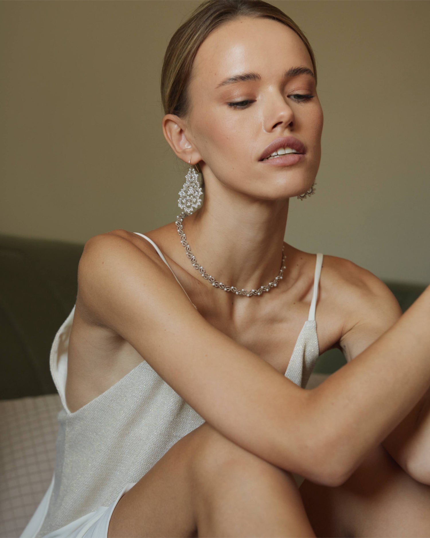 White pearl and glass necklace with silk texture on model's neck