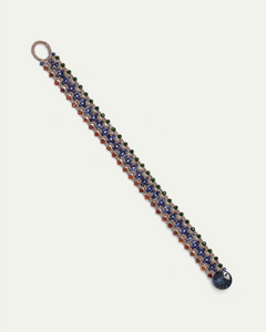 Silk bracelet with multicolor pattern featuring pearls and garnet accents with intricate detailing.