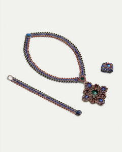 Multicolor silk ring with crystal and garnet details, showcasing textured design in vibrant shades.