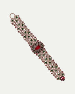 Red silk bracelet with pearls, crystals, garnet, intricate detailing, and vibrant texture.