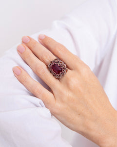 Red garnet ring with crystal accents on silk, intricate detail, available in sizes 51, 52, 54.