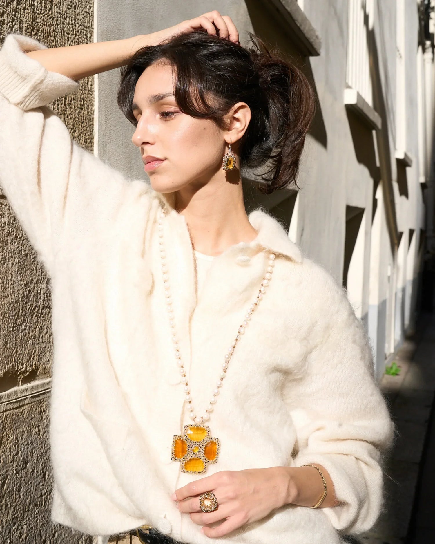 Gold Malta pendant with freshwater pearls, silk texture, and intricate crystal details, showcasing elegance and craftsmanship