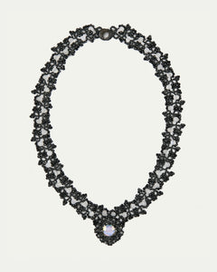 MARGUERITTE NECKLACE with black crystal, spinel, moonstone gemstones, silk threads, and pearl centerpiece.