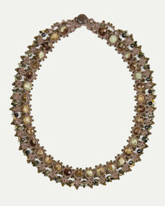 Gold Melody Necklace with intricate beaded design, featuring round gemstones and delicate detailing in side view.