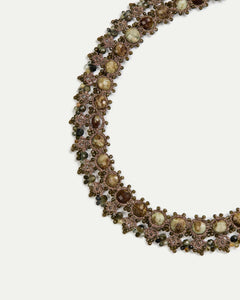 Gold Melody Necklace detail with intricate silk threading and pearl accents showing textured elegance.