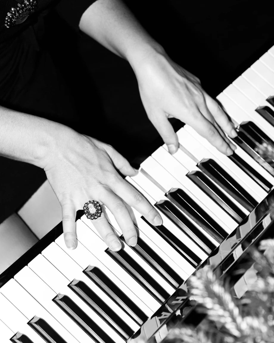MUZA RING with carved vintage glass, spinel, moonstone gemstones, black color, worn on hand playing piano.