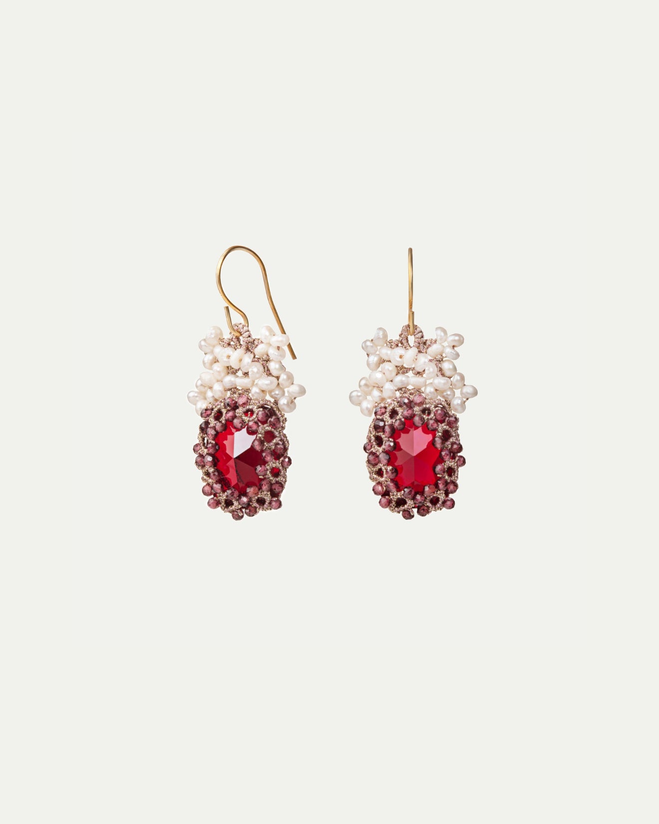 Red silk earrings with gold hooks, adorned with freshwater pearls and a large faceted center stone.