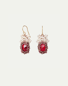 Red silk earrings with gold hooks, adorned with freshwater pearls and a large faceted center stone.