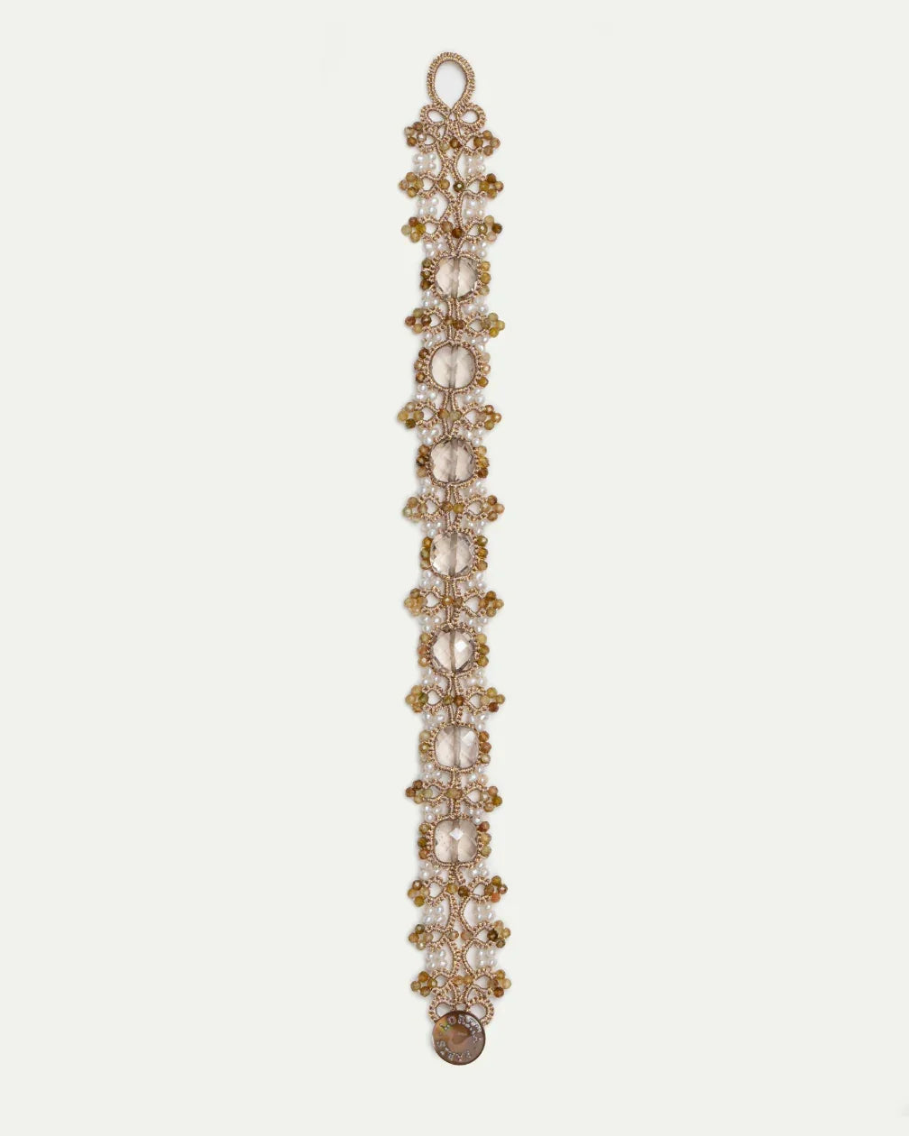 Gold PAIGE bracelet with intricate beadwork, featuring large clear gemstones interspersed with smaller accents.