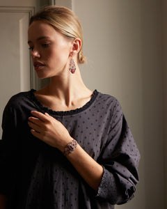 ROZALINA Bracelet in red with crystals, garnet gemstones, silk, and mother of pearl button.