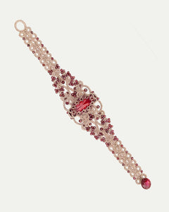 Red ROZALINA bracelet with silk, pearls, crystals, and garnet detailing, intricate woven texture.