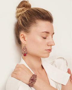 Red silk ROZALINA bracelet with pearl, crystal, and garnet detailing on wrist.