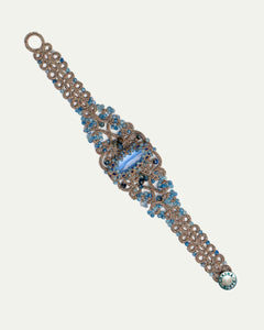 Blue silk bracelet with intricate design, featuring pearls, crystals, kyanite, and aquamarine details.