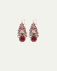 Ornate red gemstone earrings with intricate gold filigree detailing and hook closure, elegant side view angle.