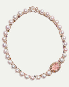 Rose gold Selene necklace with pearls, gemstone accents, and ornate medallion detailing, side view.