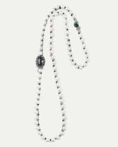 Blue SHAYLA pendant with pearls and bead accents; side view showcasing intricate detailing.