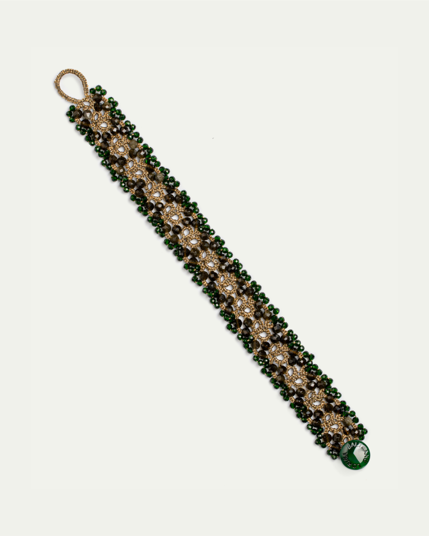 Green Tanya bracelet with intricate gold detailing and beaded design, side view angle.