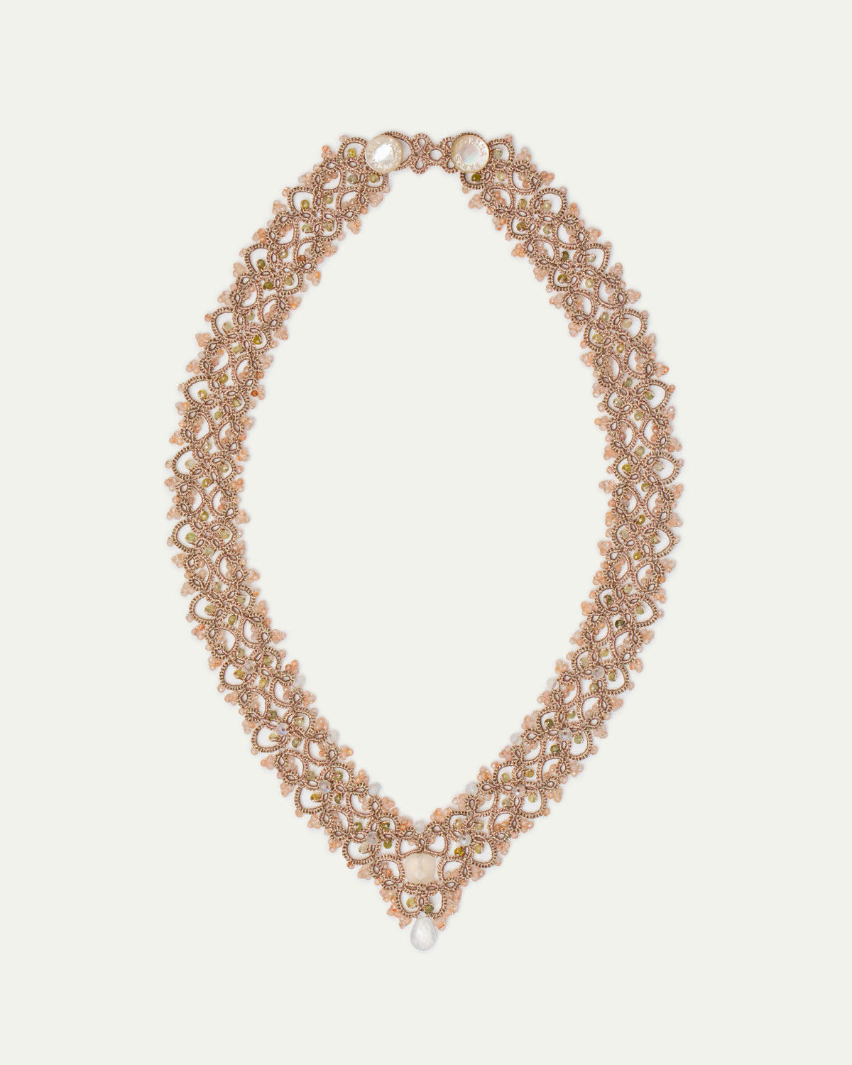 Vintaj necklace with moonstone, green garnet, gold silk threads, and mother of pearl button.