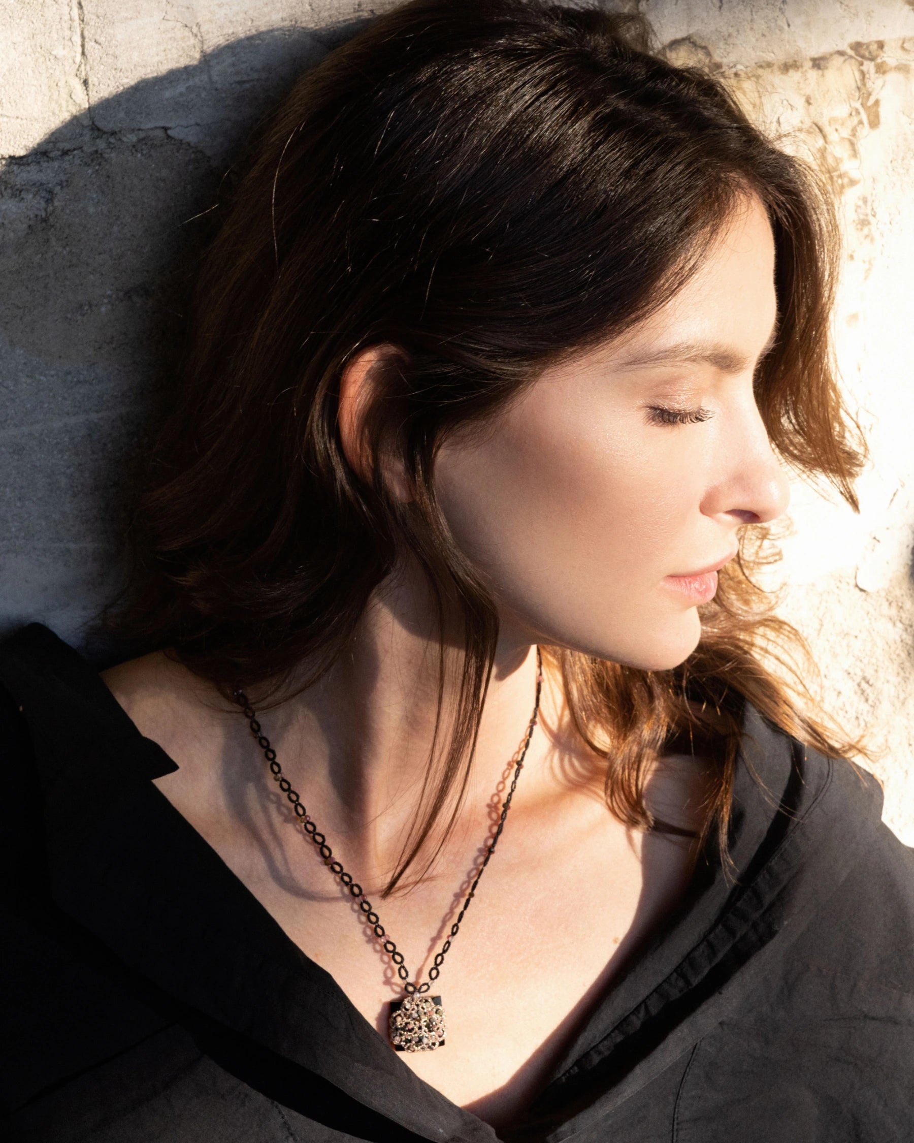 VITTORIA PENDANT with vintage glass, tourmaline gemstones, black silk thread, and mother of pearl button.